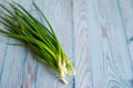 Fresh green onions on blue wooden background Royalty Free Stock Photo
