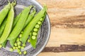 Fresh green pea pods in oriental plate