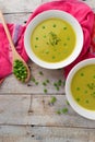 Fresh green pea soup with pea seeds. Cream soup of green peas. A delicious lunch in a rustic style Royalty Free Stock Photo