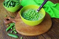 Fresh green pea soup with pea seeds and pea pods around . Selective Focus, Focus on the pea in the middle of the soup Royalty Free Stock Photo