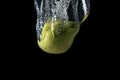 Fresh green pear in water splash isolated on black background. Minimal food concept Royalty Free Stock Photo