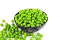 Fresh green peas in a bowl, on the table, on white background Royalty Free Stock Photo