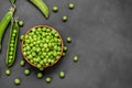 Fresh green peas with pod in wooden bowl on rustic background Royalty Free Stock Photo