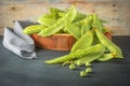 Fresh green peas pods and green peas with sprouts on green wooden background. Concept of healthy eating, fresh vegetables Royalty Free Stock Photo