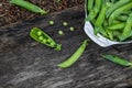 Fresh green peas pods on a wooden board, top view, copy space Royalty Free Stock Photo