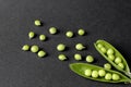 green peas in a stunt on a black background