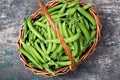 fresh green peas in a wicker basket on a rustic background Royalty Free Stock Photo