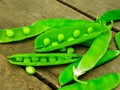 Fresh green peas on wood background. peas, pods and leaves set. Healthy food. Macro shooting.