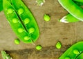 Fresh green peas on wood background. peas, pods and leaves set. Healthy food. Macro shooting.