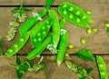 Fresh green peas on wood background. peas, pods and leaves set. Healthy food. Macro shooting.