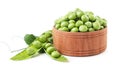 Fresh green peas in a wooden plate with a leaf on a white background. Isolated Royalty Free Stock Photo