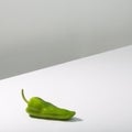 Fresh green pepper on white table, minimalism concept