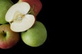 Fresh green and pink apples on black background, closeup, copy s Royalty Free Stock Photo