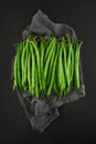 Fresh green princess beans on dark slate kitchen plate, rusty shabby chic