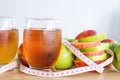 Fresh green and red apple slice and juice glasses with measuring tape Royalty Free Stock Photo