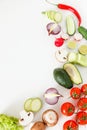 Fresh green and red vegetables lie on a white background, vegetarian food.