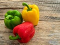 Fresh green , red and yellow bell pepper on wooden background. Royalty Free Stock Photo