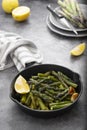 Fresh green roasted asparagus in black iron pan. Healthy, vegan food