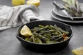 Fresh green roasted asparagus in black iron pan. Healthy, vegan food