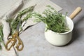 Fresh green rosemary in cookware and scissors