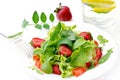 Fresh green salad with ripe tomatoes, pods of green peas and slices of strawberry. Royalty Free Stock Photo