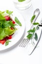 Fresh green salad with ripe tomatoes, pods of green peas and slices of strawberry. Royalty Free Stock Photo