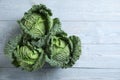 Fresh green savoy cabbages on grey wooden table. Space for text Royalty Free Stock Photo