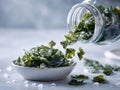 Fresh green seaweed pouring into bowl on light gray background Royalty Free Stock Photo