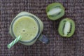 Fresh green smoothie from avocado, kiwi, banana and honey in glass mug on wooden background, closeup. Concept of healthy eating Royalty Free Stock Photo