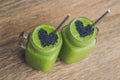 Fresh green smoothie with banana and spinach with heart of sesame seeds. Love for a healthy raw food concept Royalty Free Stock Photo