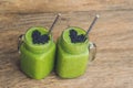 Fresh green smoothie with banana and spinach with heart of sesame seeds. Love for a healthy raw food concept Royalty Free Stock Photo