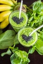 Fresh green smoothie with banana and spinach with heart of sesame seeds. Love for a healthy raw food concept. Royalty Free Stock Photo