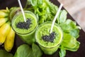 Fresh green smoothie with banana and spinach with heart of sesame seeds. Love for a healthy raw food concept. Royalty Free Stock Photo