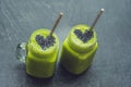 Fresh green smoothie with banana and spinach with heart of sesame seeds. Love for a healthy raw food concept Royalty Free Stock Photo