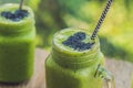 Fresh green smoothie with banana and spinach with heart of sesame seeds. Love for a healthy raw food concept Royalty Free Stock Photo