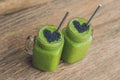 Fresh green smoothie with banana and spinach with heart of sesame seeds. Love for a healthy raw food concept Royalty Free Stock Photo