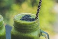 Fresh green smoothie with banana and spinach with heart of sesame seeds. Love for a healthy raw food concept Royalty Free Stock Photo