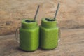 Fresh green smoothie with banana and spinach with heart of sesame seeds. Love for a healthy raw food concept Royalty Free Stock Photo