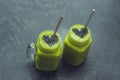 Fresh green smoothie with banana and spinach with heart of sesame seeds. Love for a healthy raw food concept Royalty Free Stock Photo