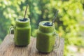 Fresh green smoothie with banana and spinach with heart of sesame seeds. Love for a healthy raw food concept Royalty Free Stock Photo