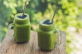 Fresh green smoothie with banana and spinach with heart of sesame seeds. Love for a healthy raw food concept Royalty Free Stock Photo