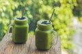 Fresh green smoothie with banana and spinach with heart of sesame seeds. Love for a healthy raw food concept Royalty Free Stock Photo