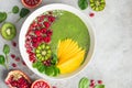 fresh green smoothie bowl with spinach, mango, kiwi and raspberry. Healthy vegan raw food Royalty Free Stock Photo