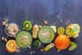 Fresh green smoothies in a glass mug with vegetables, fruits and oat chlorine on a wooden table Royalty Free Stock Photo