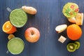 Fresh green smoothies in a glass mug on a wooden table with vegetables and fruits on a wooden table Royalty Free Stock Photo