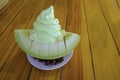 Fresh green soft icecream on melon fruit slice pieces with snack put on circle white plate. beauty sweet dessert decoration prepar