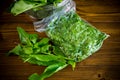 Fresh green sorrel in a vacuum bag, in a colander