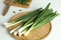 Fresh green spring onions on white table Royalty Free Stock Photo