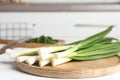 Fresh green spring onions on wooden board Royalty Free Stock Photo