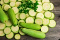 Fresh green squash, zucchini, courgette, slices and parsley  on wooden background Royalty Free Stock Photo